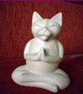 wooden buddha cat sitting in lotus posture